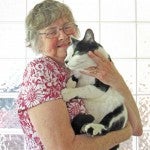 Gold winner Sally Orrill holding the cat, “Priest.” 