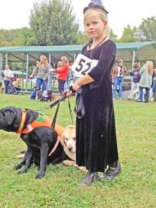 Scout Harmon poses with her pups for “Best Costume” class in last year’s “Any & All Dog Show.” (photo submitted)