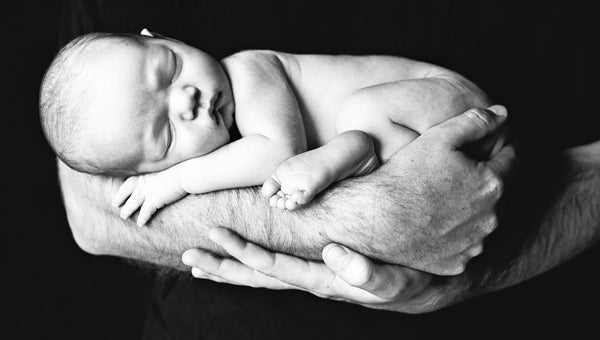 Photo of a father holding his child. (photo by Laura Eichler) 