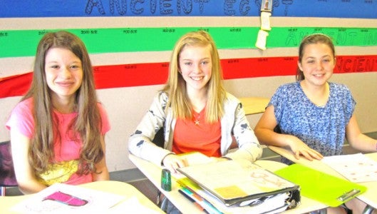 Sixth graders Angela Price, Allie Nelson and Callie Burnett take time to smile during the recent designing of their mosaic tiles at PCMS. (photos submitted by Langlee Garrett)
