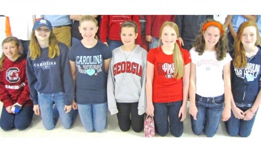 Seventh graders Ashlyn Green, Tessa Hill, Bailey Lowman, McKinnley Justus, Julianna Robbins, Izzy Jackson and Sadie Allen take a moment to pose in the cafeteria during college day at PCMS.  
