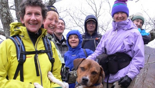 From left to right: Liz Dicey, Maureen Pratt, Bob Leibfried, Peggy Burke, Carroll Rush, Jackie Burke and Annie Ewing, with Buck and Adel (two Foothills Humane Society adoptees) on Rattlesnake Rock at the PAC Hike at Florence Nature Preserve on March 1, 2013. (photo submitted by Pam Torlina).