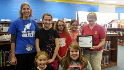 Fifth grade teacher Andrea Walter and some of her students who read poems to honor the Tenth Anniversary of Reading Is Fundamental in Polk Central Elementary. Students are Madilyn Wilson, Itzel Avellaveda-Cruz, Kellie Parker, Brendan Gracie Lee, and Kylee Mullis. Rotarian Carolyn Jones who has coordinated the program for ten years is at the far right of the picture.  