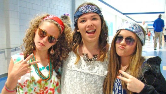 Seventh Graders Izzy Jackson, Anita Staton, and Aria Shields show off their school spirit with a little rock and roll recently at a kick off for a school wide theme of Rock the Test.  