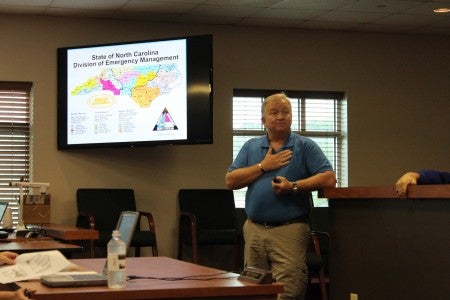 Danny Gee described the reporting structure within the Division of Emergency Management. The state is divided into the three branches (Western, Central and Eastern) and has 15 areas within the three branches. Area 15 includes Rutherford, Polk, Henderson, Transylvania, Jackson, Macon and Clay Counties. (Photo by Claire Sachse) 