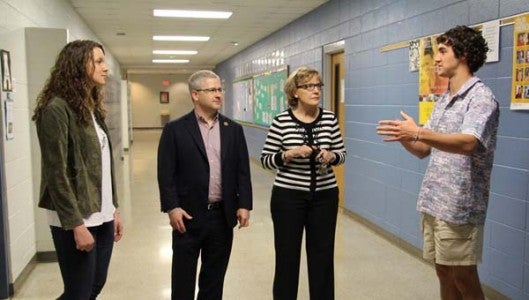 Tanner Garrett, right, Polk County High School’s student body president, leads a tour of the high school with classmate Sarah Phipps, left, senior class president, for Rep. Patrick McHenry (R-NC 10th District) on Monday. McHenry is pictured next to Mary Feagan, principal. The students and McHenry discussed the programs and classes available to PCHS students, as well as their plans for college and the future. McHenry shared anecdotes with the students about his days in high school, and met a number of school personnel. (Photo by Claire Sachse)