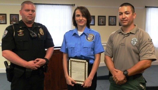 Lt. Nicholas Stott, left, and Officer Ron Diaz, right, stand with Hannah Cantrell who was recognized at Columbus’ town council meeting June 18 for her design of the official uniform patch for the Columbus Police Department Explorer Post 911. The full story, including a rendering of the uniform patch, is on page 10. (Photo submitted by Lt. Stott)