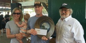 Rocky Top Barbeque takes top honors at 2015 Blue Ridge BBQ & Music Festival. Left to right are Rebecca, Mia and Walt Moulton with Carl Wharton, Blue Ridge BBQ Competition Chairman. (Photo by Paula Roberts)