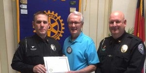 Officer Chris Ruff, Rotarian Don Lyons and Chief of Police Chris Beddingfield.