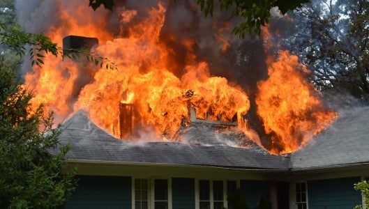 Several area departments fought a fire at 225 Wilderness Rd., Tryon on Tuesday, July 21, which destroyed the historic home owned by the Cloud family. The home was built in 1929. (photo by Brandon Shanesy)