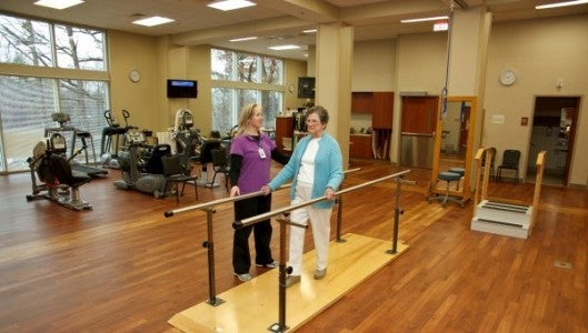 Jamie Cehlar, DPT, of St. Luke’s Hospital Rehabilitation Services, works with a patient on balance in the Rehab Center.