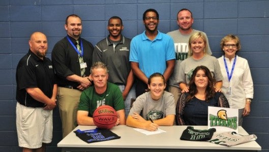 Polk County fans, teammates and coaches will all miss Hayley Kropp (front row, center), and her all-out style of basketball play, as the senior has just signed to play basketball for Guilford Technical Community College near Greensboro, on a scholarship. In the front row with Kropp are her parents, Karl and Teresa Kropp. In the back, from left, are Guilford Titans' head basketball coach, Bobby Allison (not the NASCAR driver); Polk athletic director, Brandon Schweitzer; Titans' assistant coach, Dejuane Bowe; Polk assistant coaches Stacey Shields and Billy Alm; PCHS head coach, Brandy Alm; and PCHS Principal Mary Feagan. 