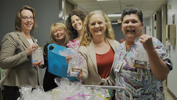 Members of the senior executive team at St. Luke’s Hospital delivered goodie bags on Monday, May 9, to commemorate National Hospital Week. Presnell, Colvin, and Norville of the executive team delivered the bags early Monday to Davis and Littlejohn in Radiology. Goodie bags were provided by St. Luke’s Hospital Foundation. From left to right are Elizabeth Presnell, Teresa Davis, Meshelle Colvin, Amy Norville, Cindy Littlejohn.