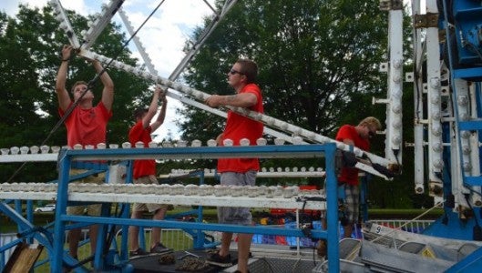 ABC Party Rentals and Amusements, based in Greenville, S.C., is shown setting up rides at Stearns Park for the Fabulous Fourth of July celebration to be held in downtown Columbus on Monday starting at 10 a.m. Local vendors, carnival food, rides, games, and lots of music will draw thousands, with the grand finale fireworks scheduled to start at 9:45. (Photo by Michael O'Hearn) 