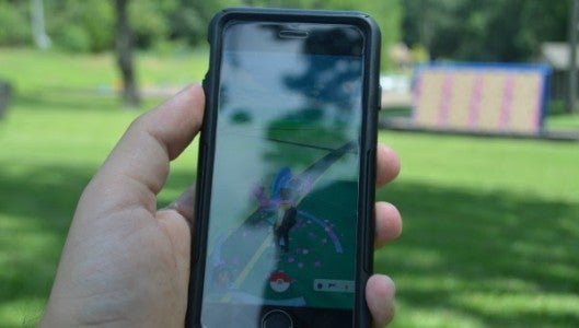 The app utilizes the player's GPS and camera to generate Pokemon creatures to capture and train. Players create a "trainer" avatar to play the game. Selim Nedhi showed off his character Thursday afternoon at Brookwood Park. (Photo by Michael O'Hearn)