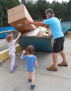 Peter Markovic with his grandchildren Sophia, 4, and Conner, 2, recycling on a Saturday at the landfill.