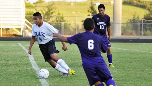 Polk County’s Erik Cruz frustrates a Mitchell player after taking possession of the ball.