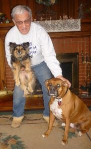 Lennie is pictured with his Chihuahua, Pablo, and Boxer, Charma.