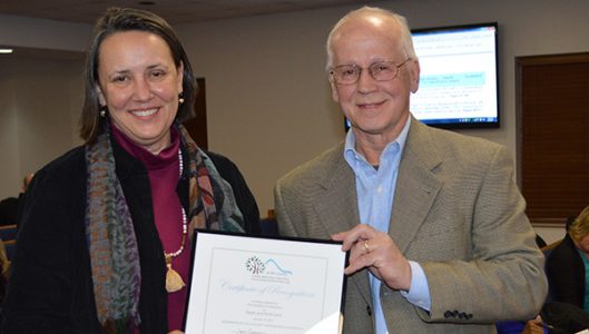 The Lane family received a Polk County Appearance Commission Beautification Award for its 2016 revitalizations to the Missildine building in downtown Tryon. This was the Lane family’s fourth year in a row receiving the award. Pictured is Gayle Lane receiving the award from Polk County Appearance Commission Chair Joe Cooper. (photo by Leah Justice)