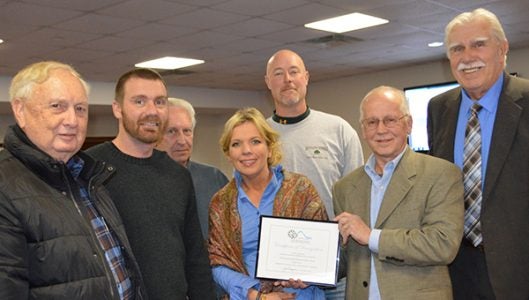 The Polk County Board of Commissioners received a Polk County Appearance Commission Beautification Award for its 2016 decisions to make improvements at the Doughboy statue, litter pickup and for the courthouse retaining wall. Accepting the award from appearance commission chair Joe Cooper was former commissioner Ted Owens, Thompson’s Landscaping owners Cory and Erin Thompson, former commissioner Keith Holbert, Jay’s Lawn and Landscaping owner Jay Harden and current commissioner chair Tommy Melton. (photo by Leah Justice)