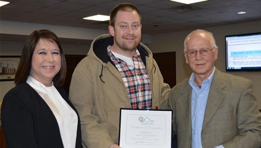 The Town of Tryon received a Polk County Appearance Commission Beautification Award for its work on downtown streetscape projects. Accepting the award from appearance commission chair Joe Cooper, right, was Tryon Community Development Director Paula Kempton and Tryon Town Manager Zach Ollis. (photo by Leah Justice)