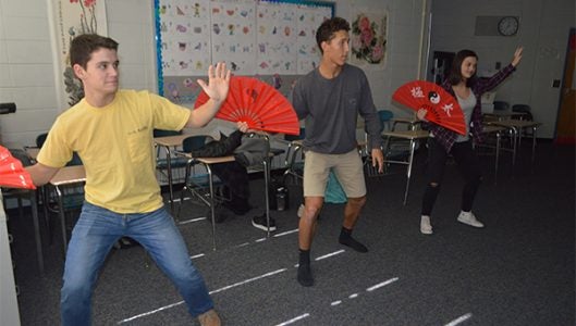 Jaylon Bontrager, Dillon Overholt and Hope Patterson, Chinese I students, learned a traditional Chinese dance during class on Wednesday afternoon to celebrate Chinese New Year. (Photo by Michael O’Hearn)